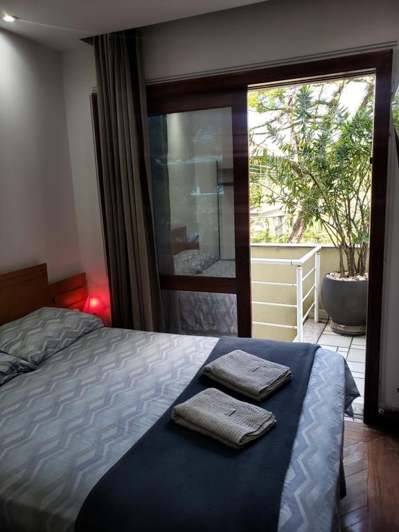 a bedroom with a bed with two towels on it at Pousada Monte Sião in Sao Paulo