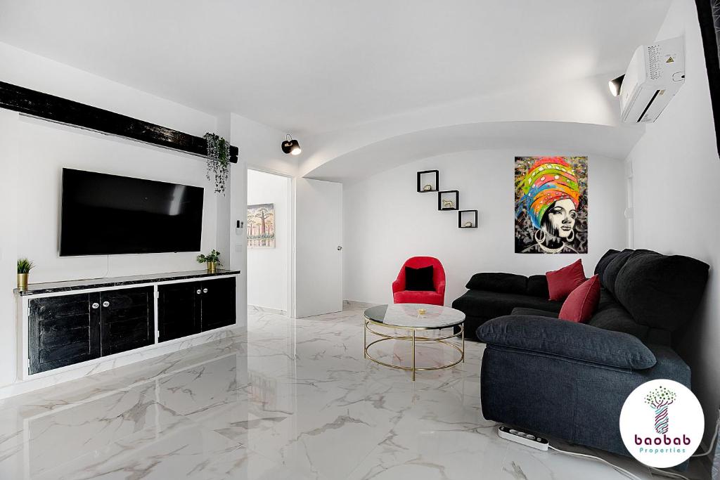 a living room with a couch and a flat screen tv at Villa Bellagio in Albufeira