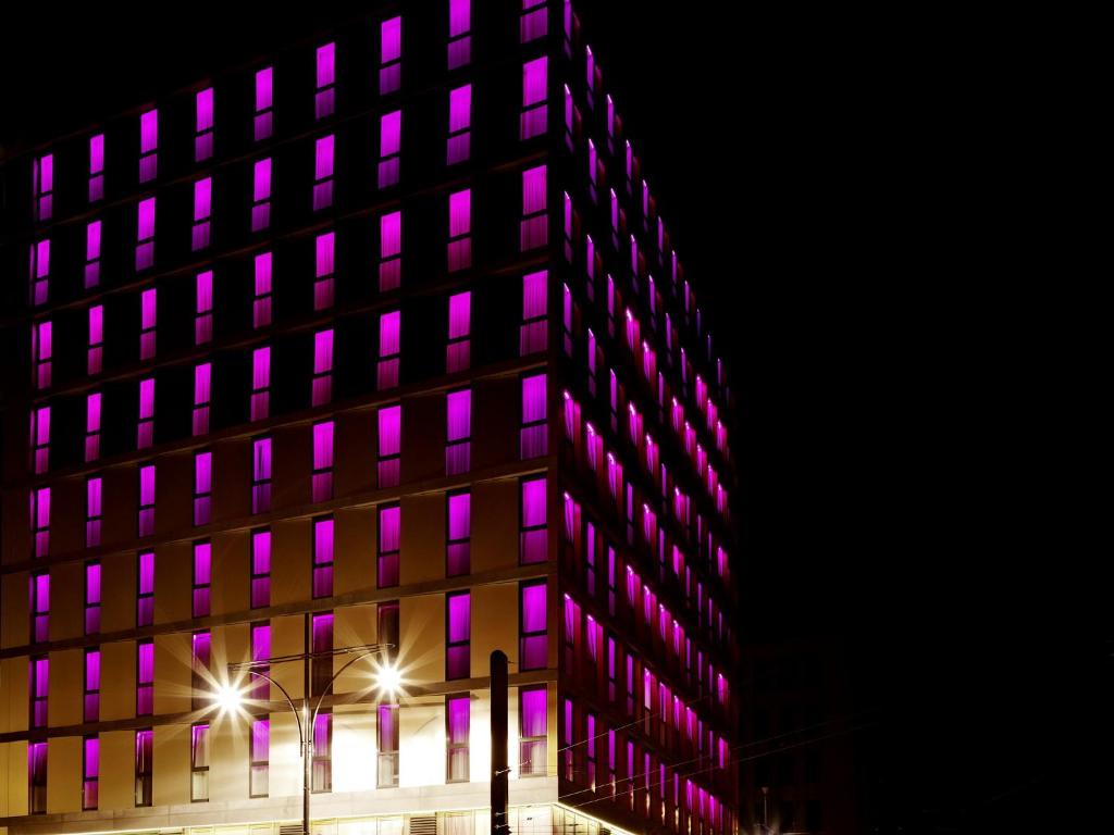 a building with purple lights on the side of it at VISIONAPARTMENTS Berlin - contactless check-in in Berlin