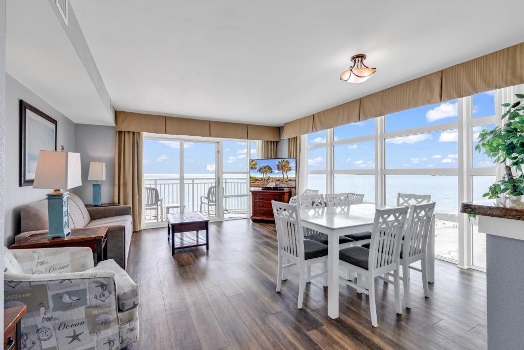 a living room with a table and chairs at Stunning Condo with Wall-to-Wall Windows Overlooking Ocean in Myrtle Beach