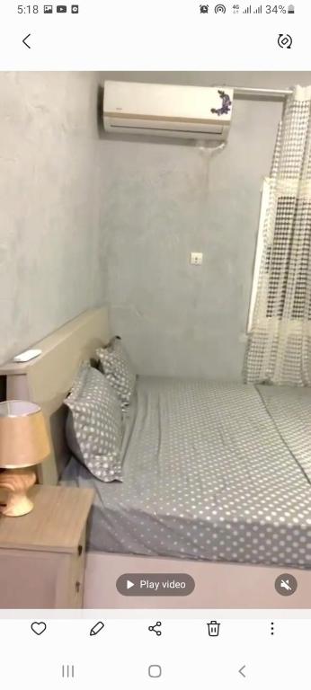 a small bedroom with a bed and a night stand at Apartment Ami in Nouakchott