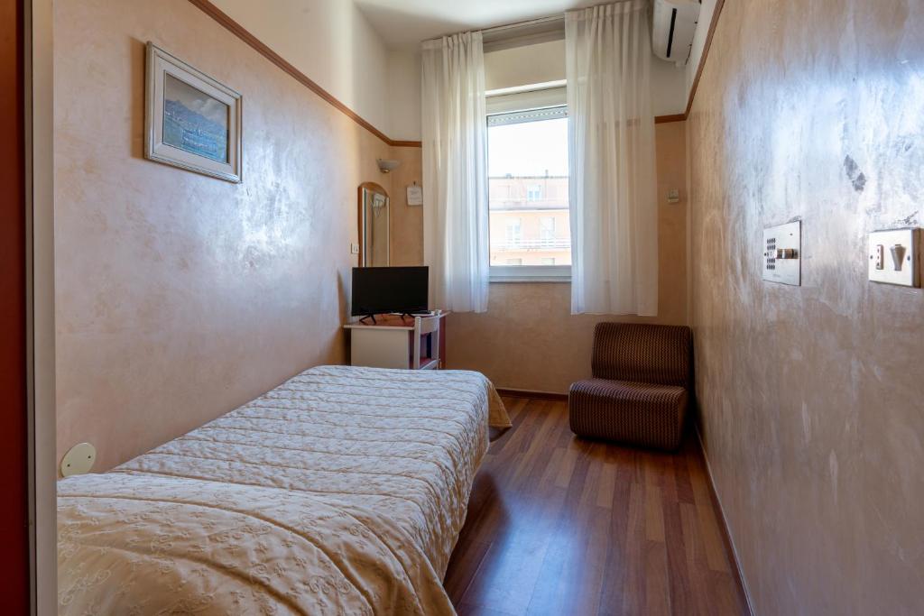Postel nebo postele na pokoji v ubytování Hotel Britannia Rimini Marina centro