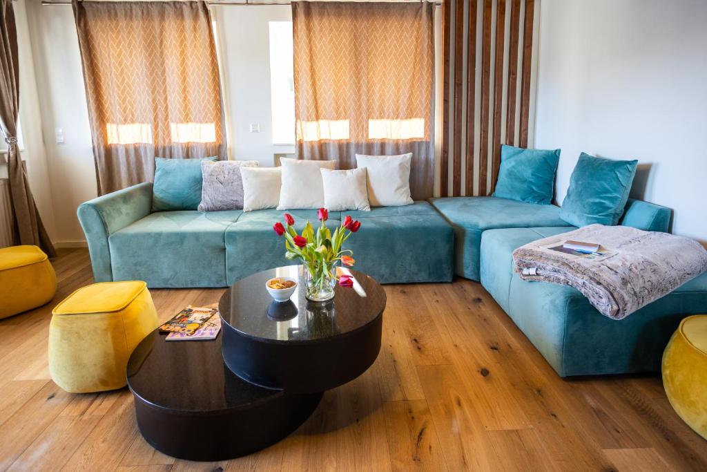 een woonkamer met een blauwe bank en een tafel bij Sope Skylodge 05 - Lorena's Bollenhut - Oberried, Schauinsland in Oberried