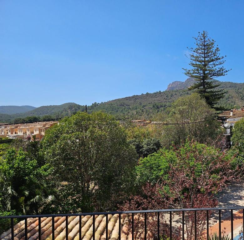 a view of a mountain with a fence and trees at Ca Vicent in Estivella