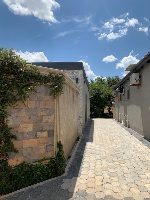 a cobblestone alley with a building and a wall at Ultimate Escape in Lusaka