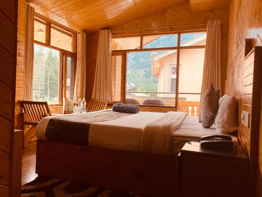 a bedroom with a large bed with a large window at Jagdish Guest House in Bhiwāni