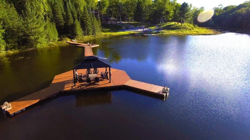 an aerial view of a dock in the middle of a lake at Footprints Resort in Bancroft