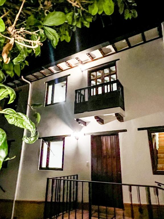 a building with a balcony on the side of it at Casa Colonial en el corazón de Villa de Leyva Casa serena in Villa de Leyva