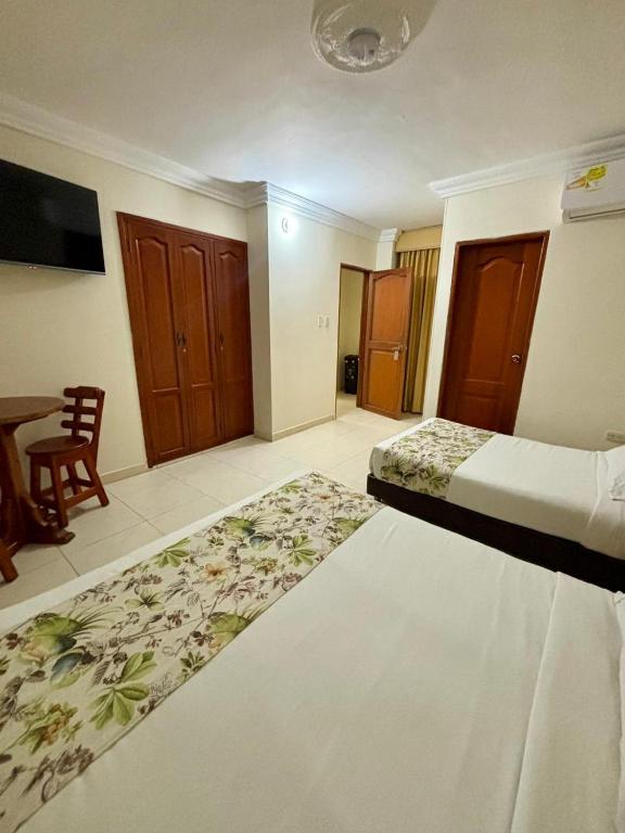 Postel nebo postele na pokoji v ubytování Hotel San Miguel Imperial