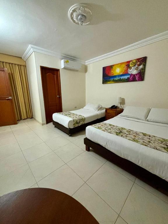 Postel nebo postele na pokoji v ubytování Hotel San Miguel Imperial