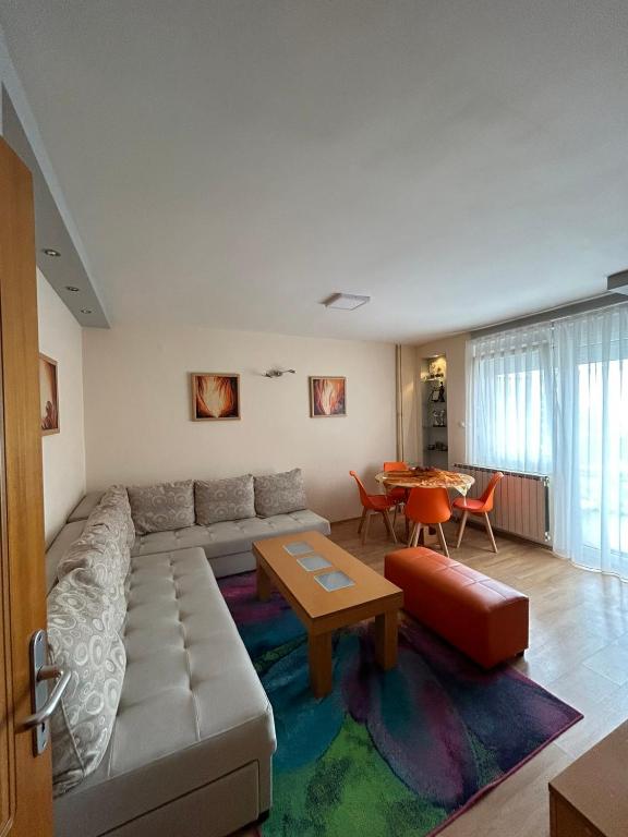 a living room with a couch and a table at TOP Center Apartment in Bitola