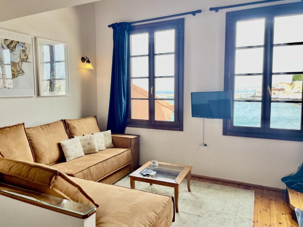 a living room with a couch and a tv at Erietta Suites in Chania Town