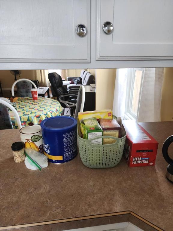 a kitchen counter with food items on a counter top at Cozy bungalow in Calgary