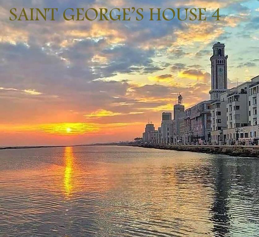 a sunset over a river with a clock tower and buildings at SAINT GEORGE'S HOUSE 4 Bari in Bari