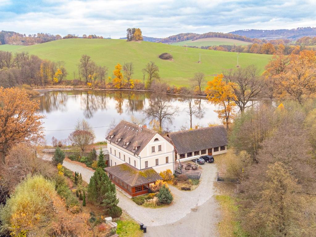 an aerial view of a house next to a lake at Mlýn Mitrovice in Příbram