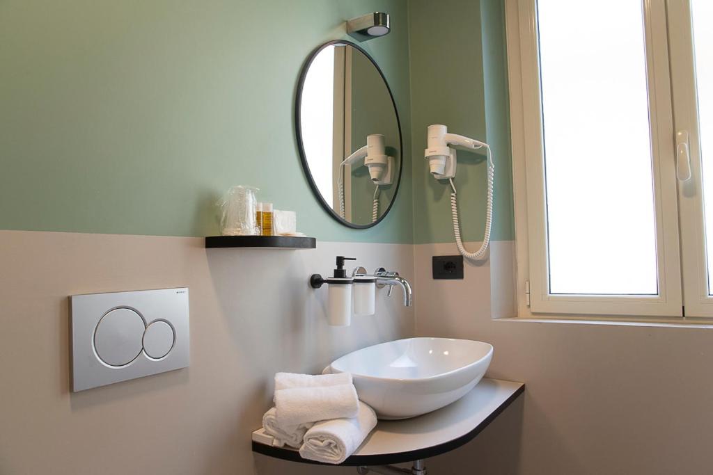a bathroom with a sink and a mirror at Hotel Bolivar in San Benedetto del Tronto