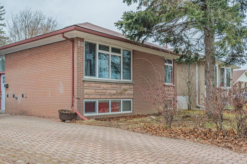 a brick house with a large window at Littlewood Properties in Toronto