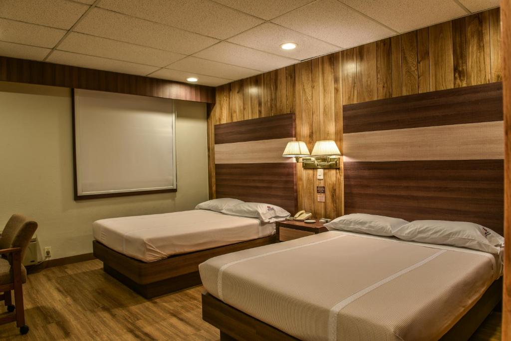 เตียงในห้องที่ Oliver Inn Tlalnepantla