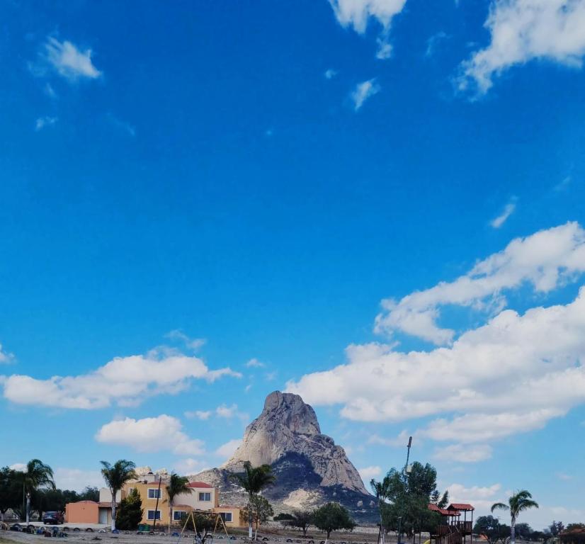 a mountain in front of a blue sky with clouds at Roselyn in Bernal