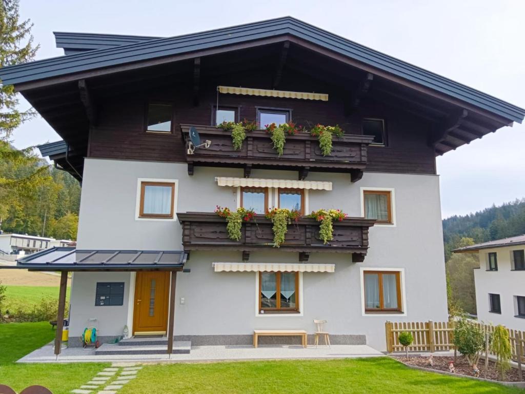 a house with a balcony with plants on it at Schönauer Top 1 in Mariastein