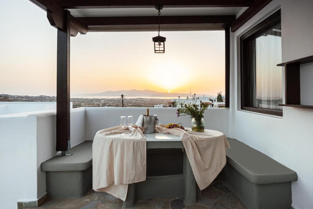 a table in a room with a view of the ocean at Aegean Moments in Glinado Naxos