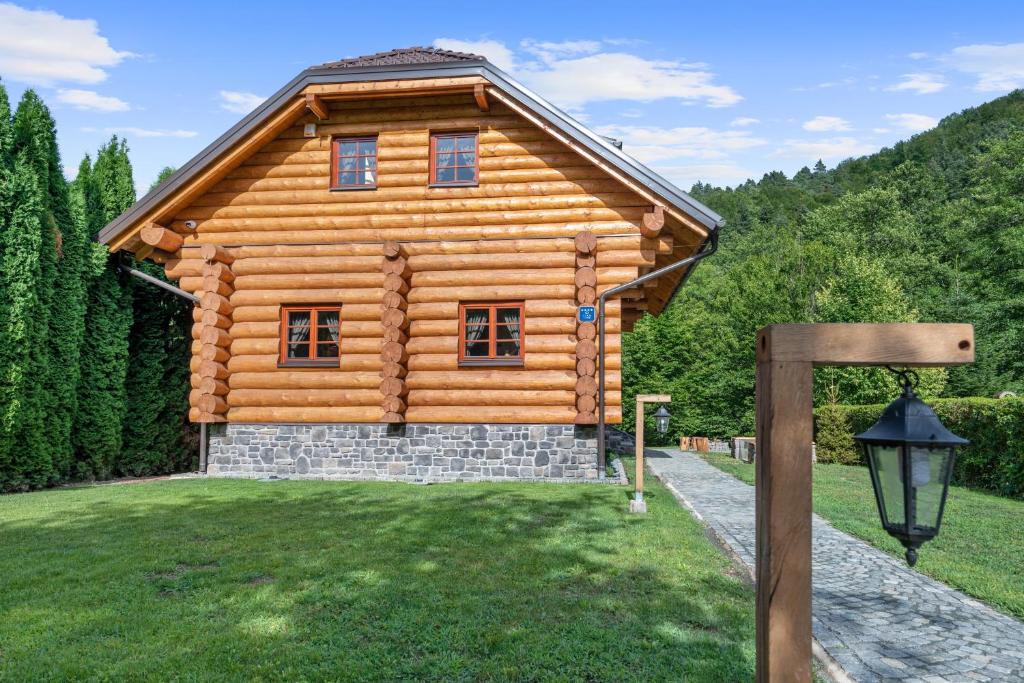 a log cabin with a sign in front of it at Holiday house with a swimming pool Brod na Kupi, Gorski kotar - 23012 in Brod na Kupi