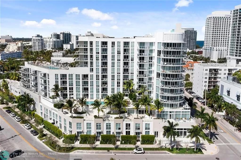 an aerial view of a large white building with palm trees at The Glamour of Upscale Downtown Ft. Lauderdale in Fort Lauderdale