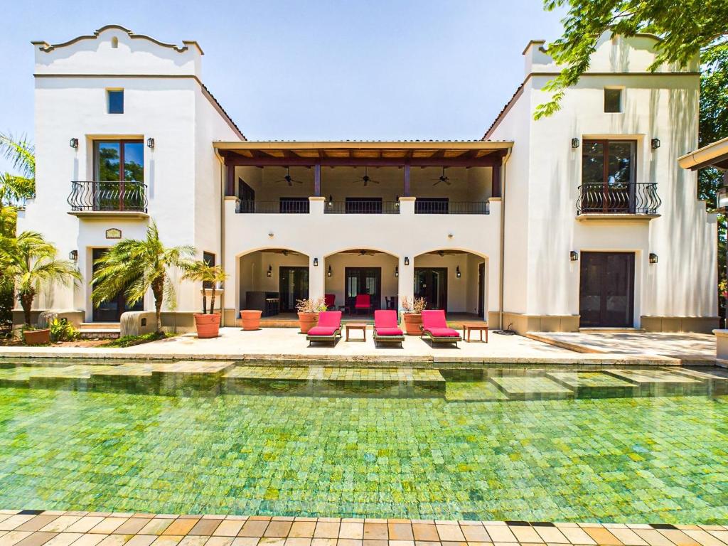 an exterior view of a house with a swimming pool at Casa Orquidea-6 BR Home in Hacienda Pinilla in Playa Avellana