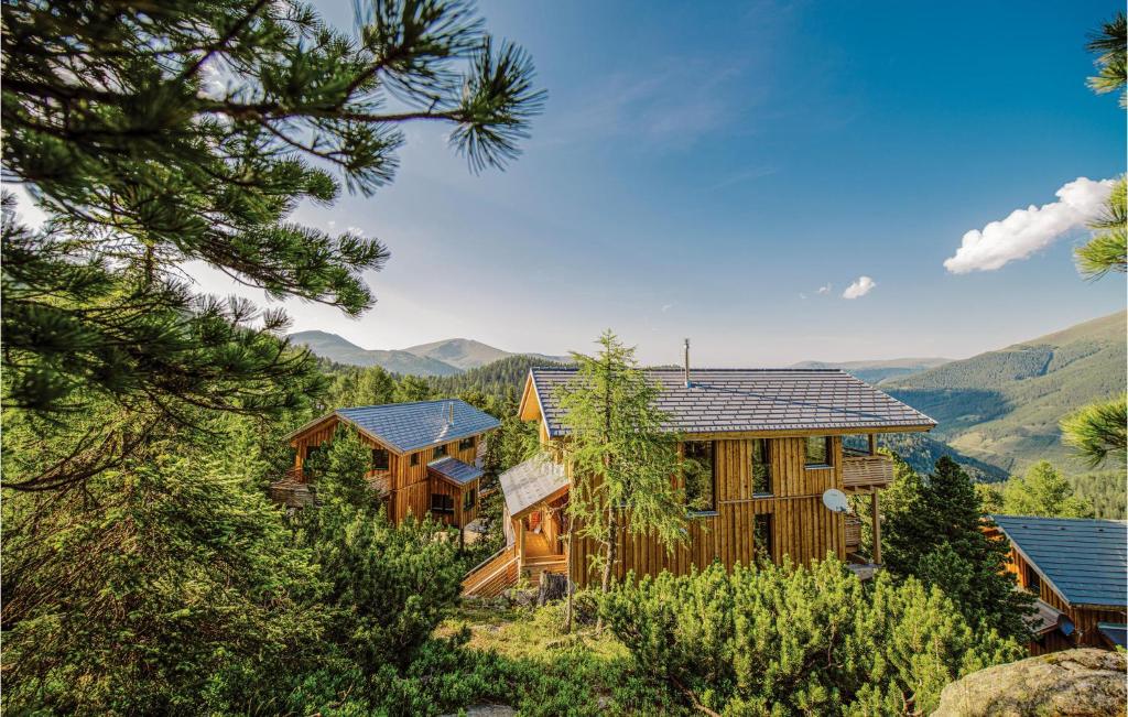 a log home with mountains in the background at Awesome Home In Turrach With 5 Bedrooms And Sauna in Turracher Hohe