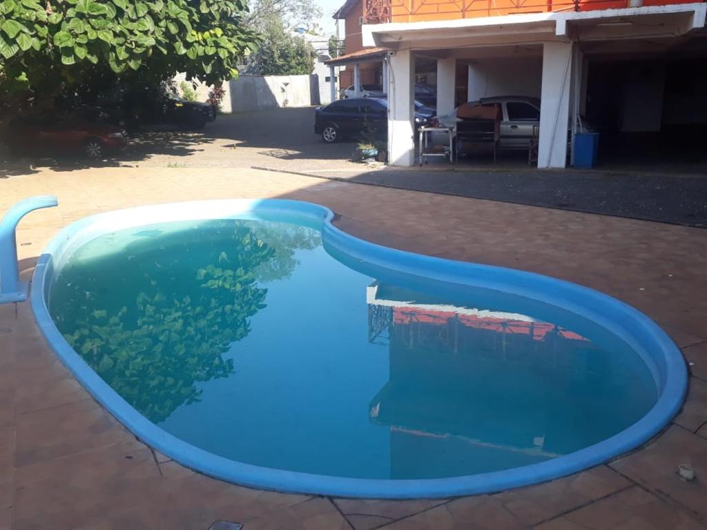 a pool of blue water in a yard at Hotel Fontes do Iguaçu in Foz do Iguaçu