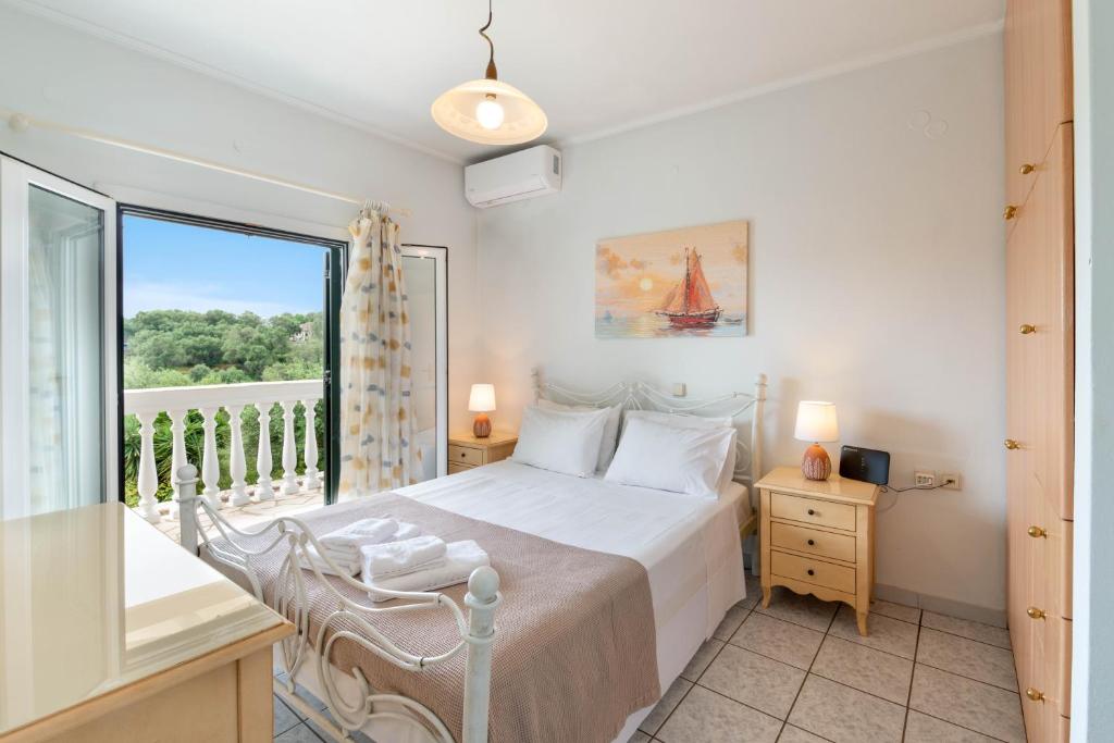 a bedroom with a bed and a balcony at Militsa House in Gaios