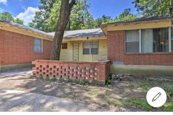 a brick house with a tree in front of it at COZY PRIVATE ROOM #2 in Dallas