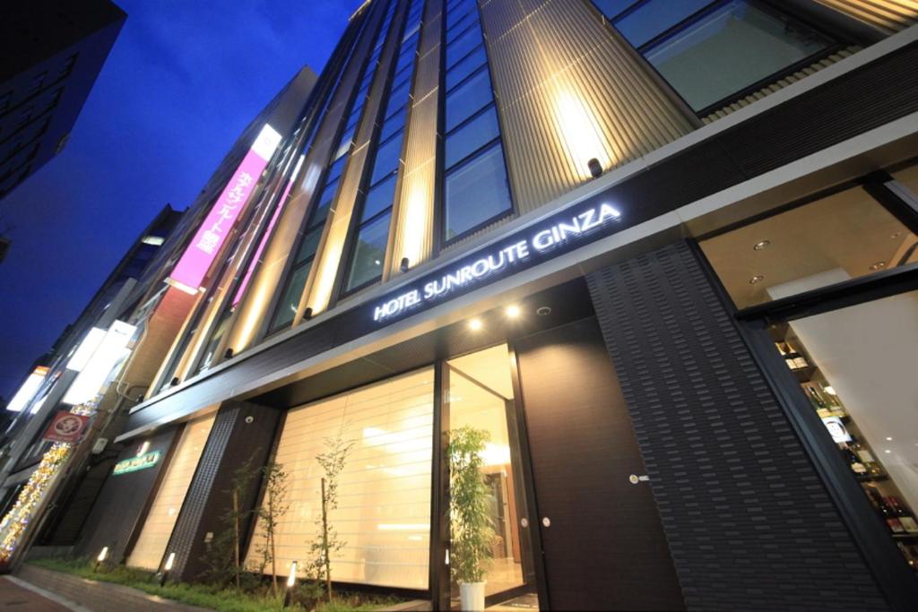 a building with a sign on the front of it at Hotel Sunroute Ginza in Tokyo