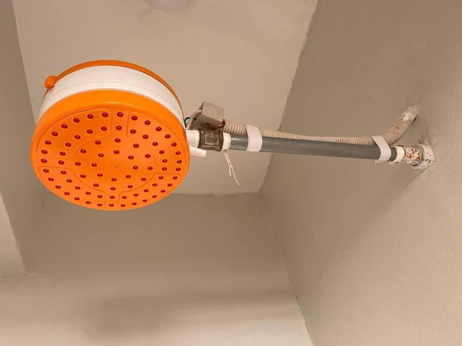 an orange and white pipe hanging from a ceiling at B&M homes, ensuite 2 bedrooms Meru in Meru