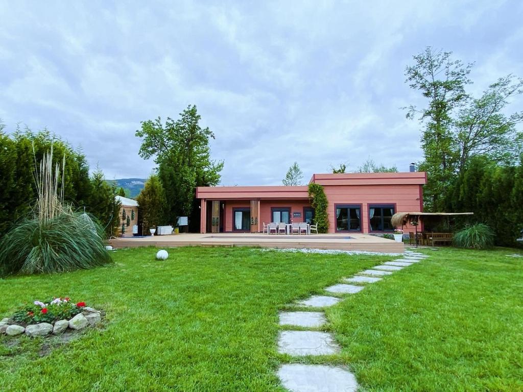a house with a green yard with a walkway at Lake Harmony Sapanca in Sapanca