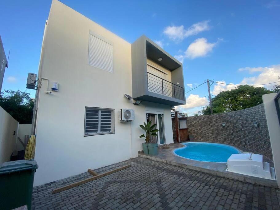 a house with a swimming pool in the backyard at 3 bedroom private villa in calm area in Grand Baie