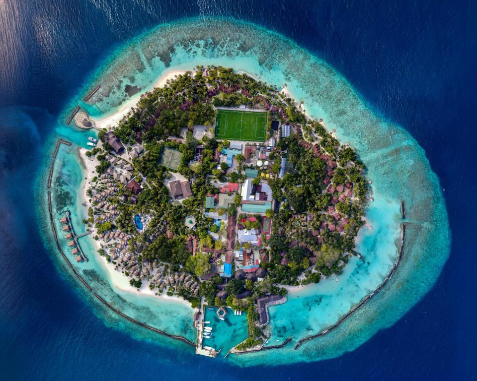an aerial view of a tropical island in the ocean at Bandos Maldives in North Male Atoll