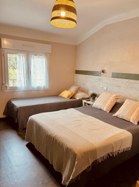 Postel nebo postele na pokoji v ubytování Hôtel le Nid