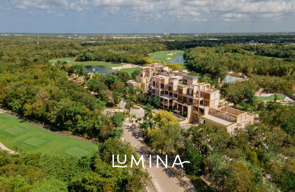 an aerial view of the luna resort and golf course at Lumina at The Village Luxury Residences in Corasol in Playa del Carmen