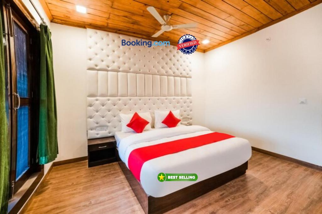 a bedroom with a bed with red pillows at Goroomgo Blue Moon Resort Lake View Mall Road Bhimtal - Best Seller in Nainital