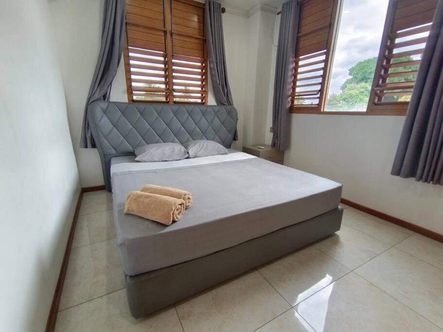 a bedroom with a bed with a towel on it at Exquisite 3-Bedroom Unit With Free Parking. in Nadi