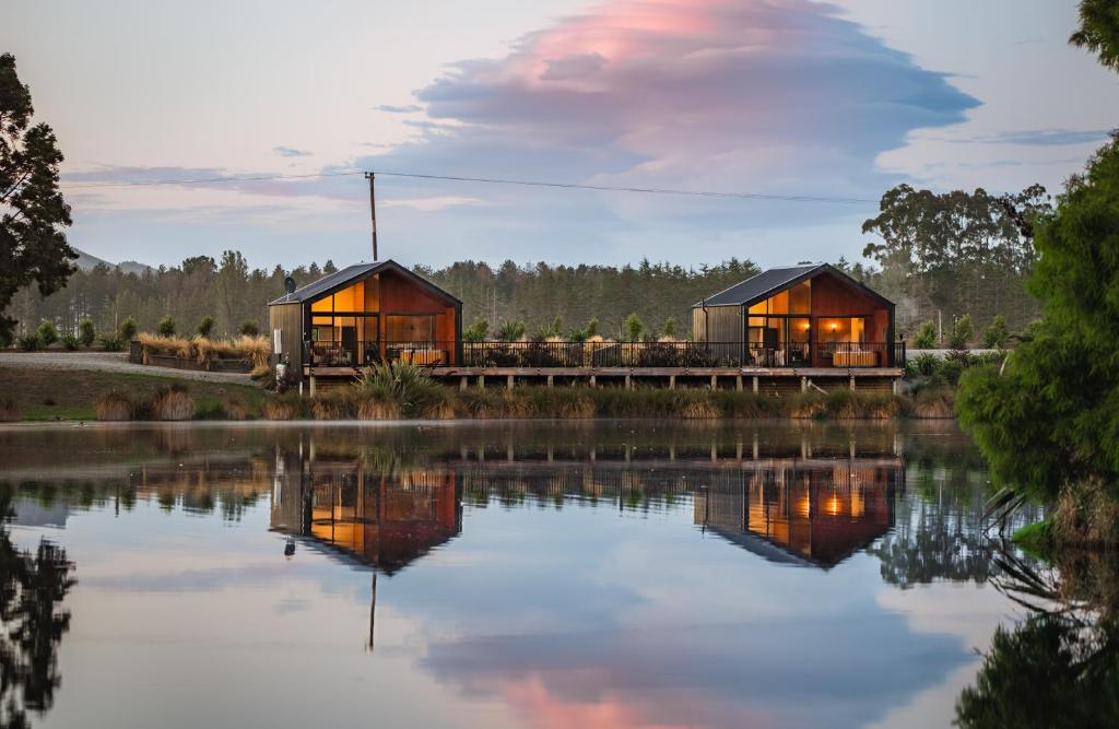 a house by the water with its lights on at HighTree Chalets 