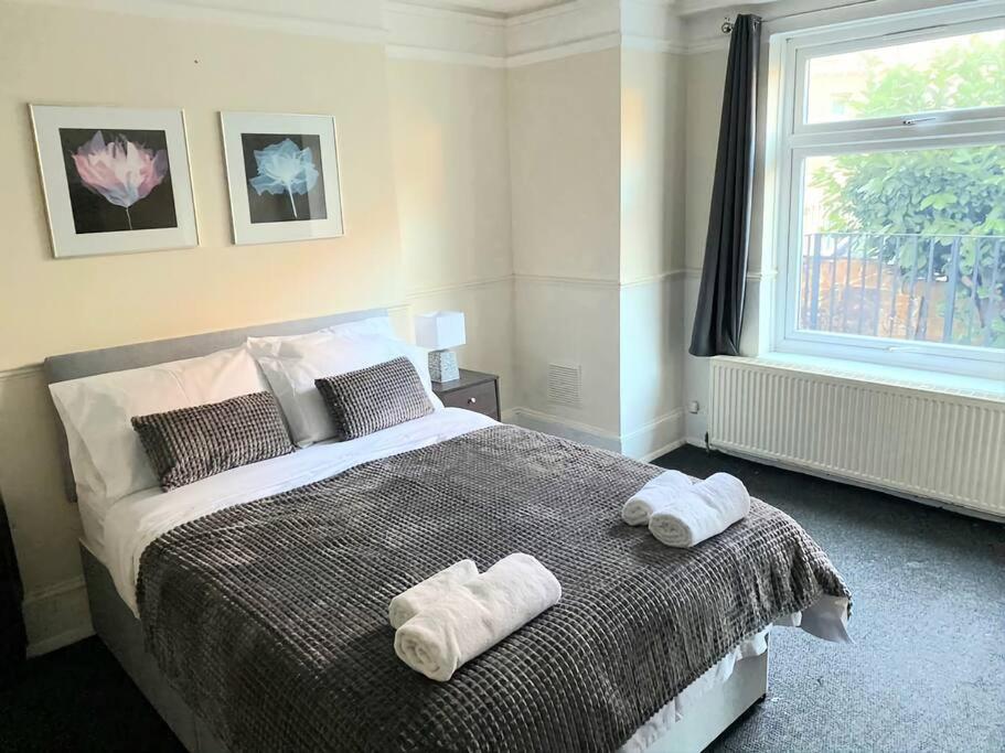 a bedroom with a bed with towels on it at Gravesend 1 bedroom Apartment in Kent