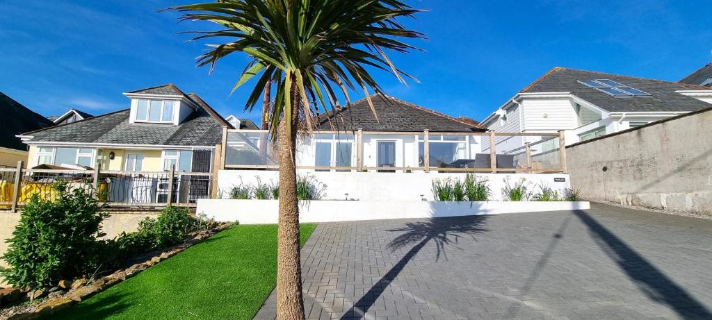 a palm tree in front of a house at Parkside, Perranporth in Perranporth