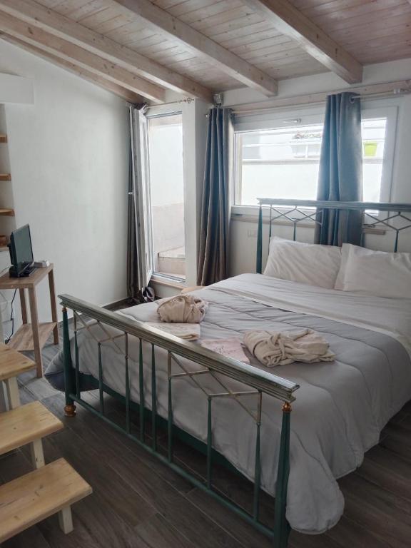a bedroom with a bed with a metal frame and a window at Casa Vacanza Altamura in Altamura