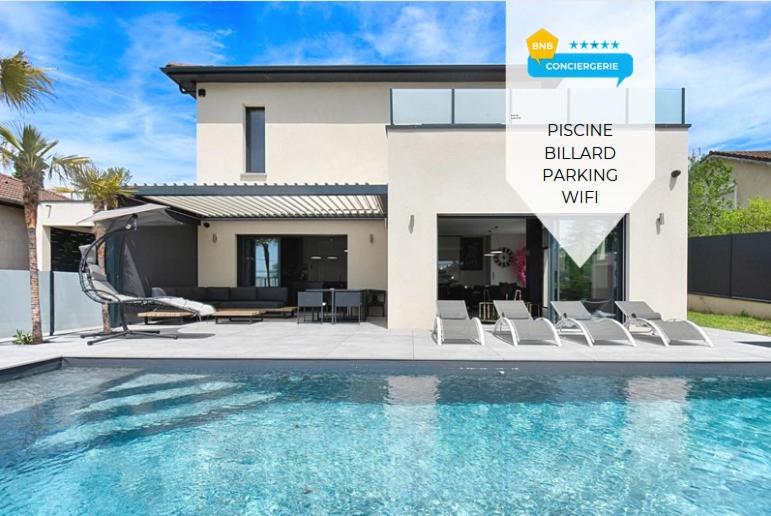 a villa with a swimming pool in front of a house at Villa Vice City -proche Eurexpo/Groupama stadium/LDLC Arena in Chamagnieu