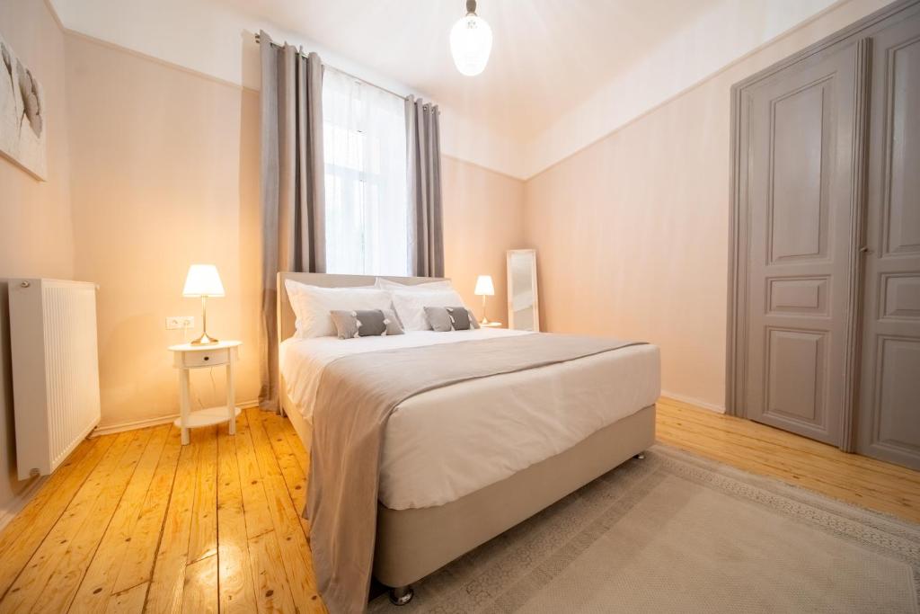 a bedroom with a large bed and a window at Oikia Tripodon in Athens