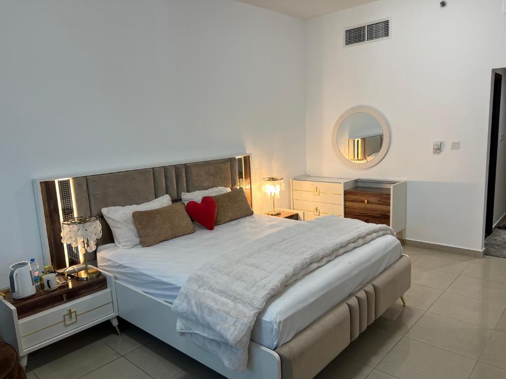 a bedroom with a large bed and a mirror at Ft 22 R1 Luxury Room attach bath Seaview Beach access Ajman غرفة فاخرة مع إطلالة على البحر وإمكانية الوصول إلى الشاطئ in Ajman 