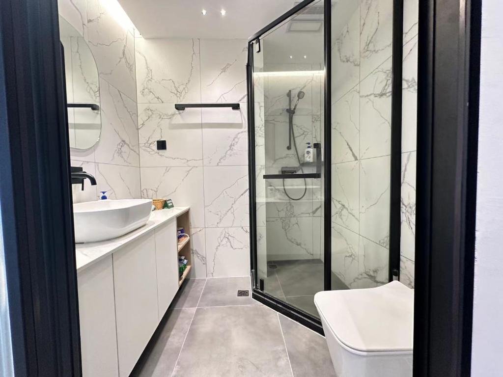 a bathroom with a shower and a sink and a toilet at 同济佳苑公寓 in Shanghai