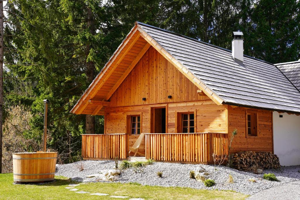 a wooden cabin with a gambrel roof at Alpine Retreat Apartments Šurc in Rateče